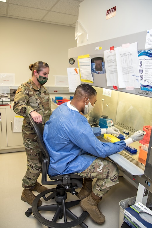 Airmen prepare patient samples for COVID-19 extraction.