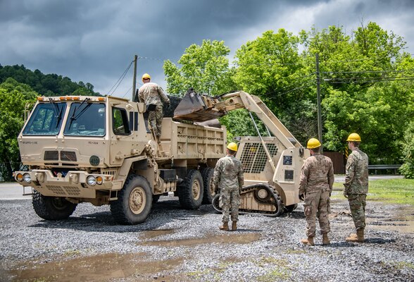 Members of the West Virginia National Guard’s 1092nd Engineer Battalion conduct debris removal operations in Minden, Fayette County, West Virginia, June 19, 2020. The community was flooded earlier in the week when a severe storm dumped more than three inches of rain in less than an hour leading to flash flooding that damaged more than 100 homes and structures.