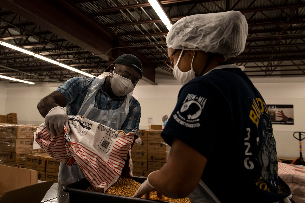 Airmen bag popcorn for community outreach.