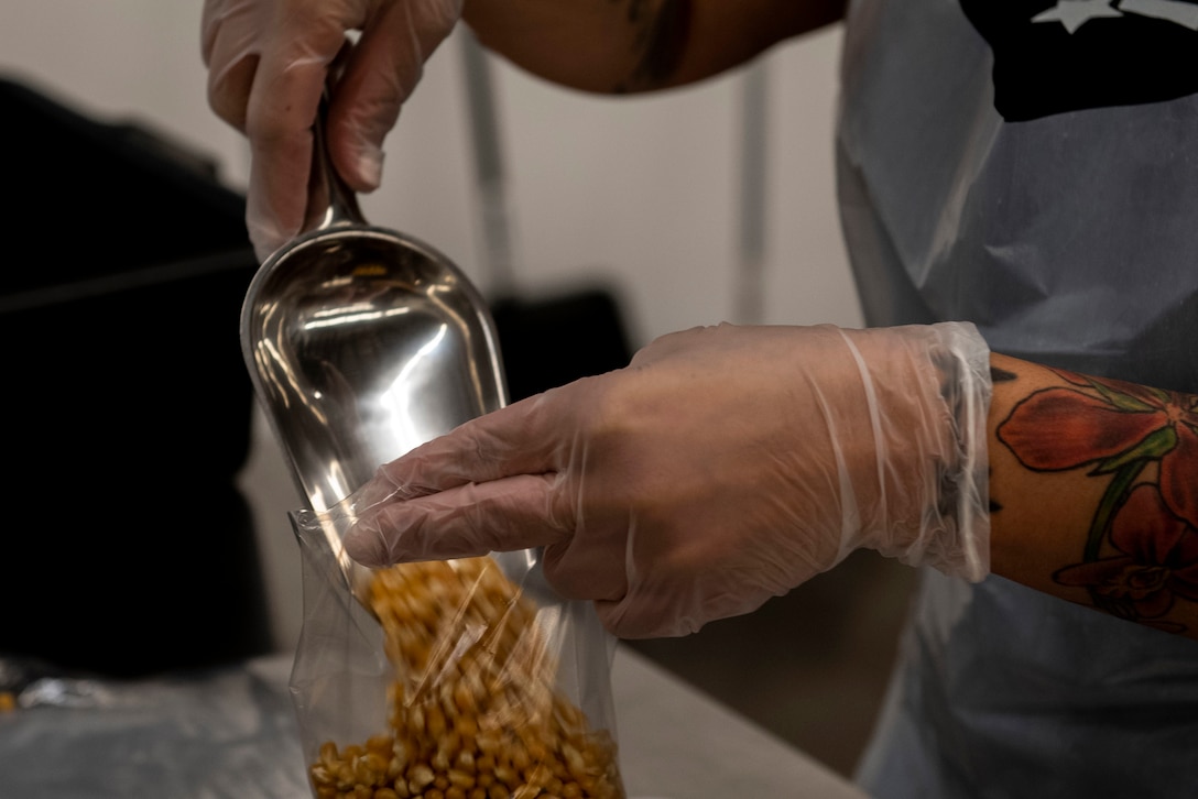 Airmen bag popcorn for community outreach.