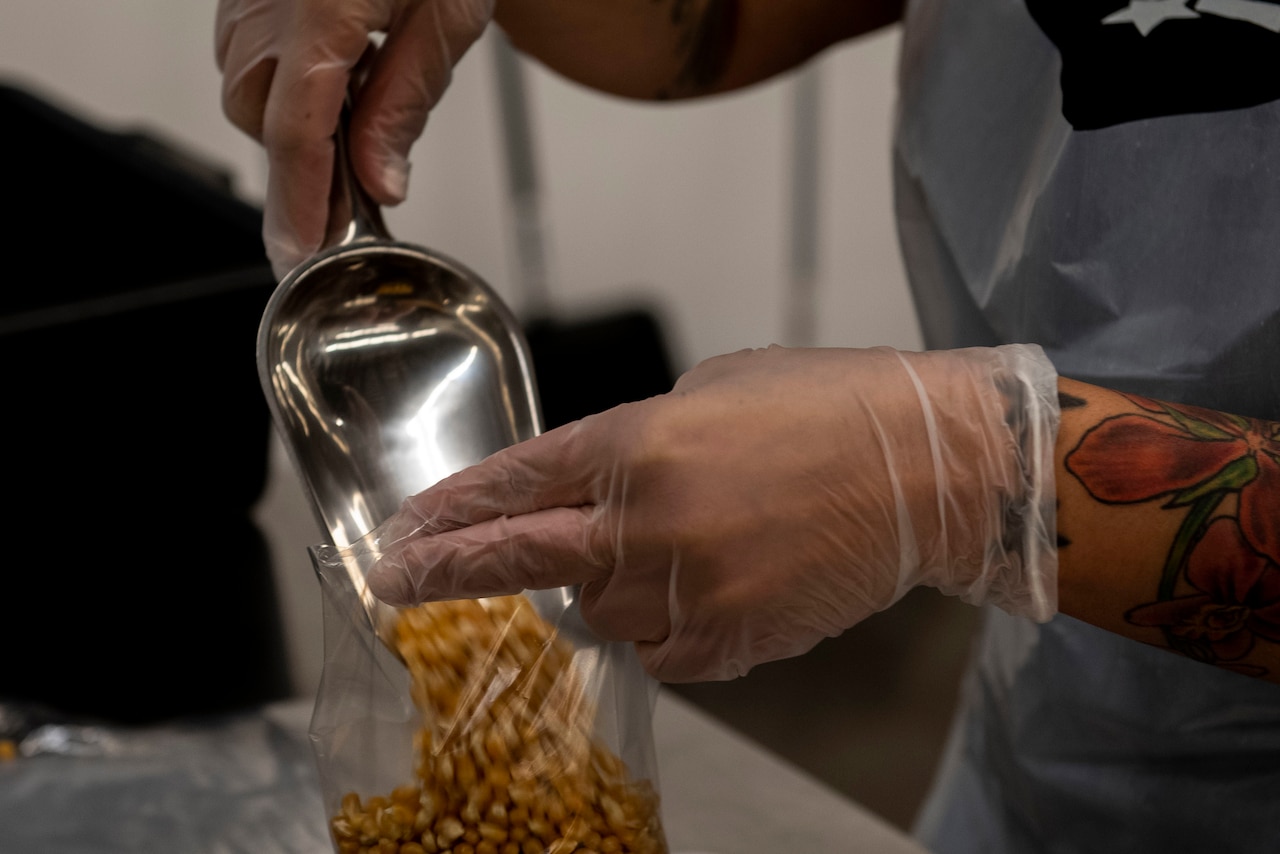 Airmen bag popcorn for community outreach.