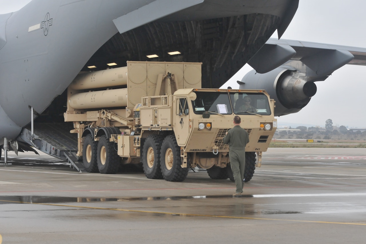 Missile defense system drives off C-17 ramp.