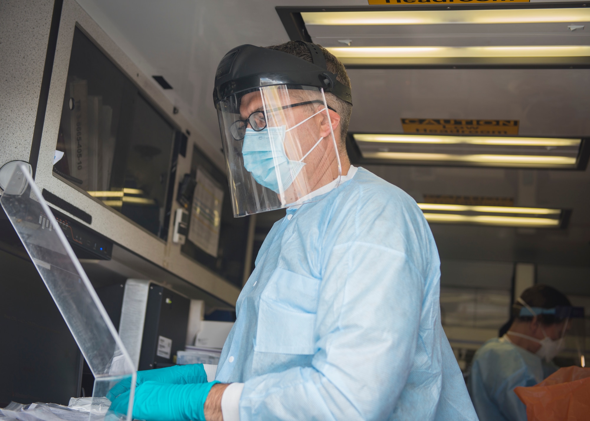 U.S. Army Capt. Justin Copeland, 14th Civil Support Team medical operations officer, prepares COVID-19 testing samples for analysis in the team’s analytical laboratory system vehicle at Bradley Air National Guard Base, East Granby, Connecticut, June 19, 2020. The team worked in partnership with the New York National Guard 24th Civil Support Team, 103rd Medical Group and Connecticut Department of Public Health to provide COVID-19 testing to Connecticut Air National Guard personnel. (U.S. Air National Guard photo by Staff Sgt. Steven Tucker)