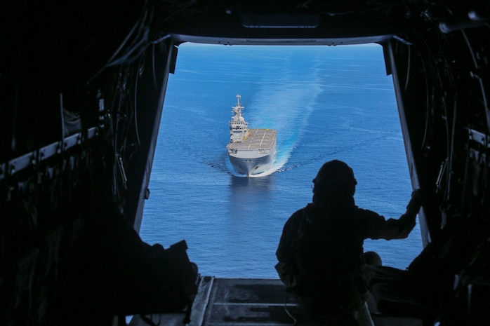 200624-M-IR130-1047 MEDITERRANEAN SEA (June 24, 2020) Cpl. Tyler Truong, MV-22B Osprey crew chief, assigned to Marine Medium Tiltrotor Squadron (VMM) 365 (reinforced), 26th Marine Expeditionary Unit (MEU), observes the French Navy amphibious assault ship Mistral June 24, 2020. 26th MEU is conducting operations in U.S. 6th Fleet in support of regional allies and partners, and U.S. national security interest in Europe and Africa. (U.S. Marine Corps photo by Cpl. Gary Jayne III/Released)