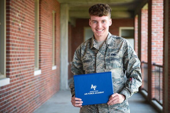Airman 1st Class Chad Schuch, 62nd Aircraft Maintenance Squadron crew chief, holds his acceptance certificate to the U.S. Air Force Academy (AFA) Preparatory School in Colorado Springs, Colo., at Joint Base Lewis-McChord, Wash., June 19, 2020. The AFA accepts about 1,000 students per year, with 170 spots available for prior enlisted applicants. (U.S. Air Force photo by Airman 1st Class Mikayla Heineck)