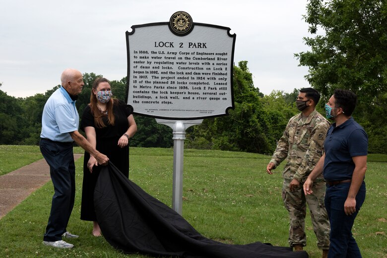 Jeff Syracuse, Metro Council member for District 15; Jessica Reeves, who oversees the historic markers program with the Metro Historical Commission; Lt. Col. Sonny Avichal, U.S. Army Corps of Engineers Nashville District commander; Bill Holman, grandson of former lockmaster Red Holman, unveil a historical marker during a ceremony at Lock 2 Park, highlighting the historical relevance of Lock and Dam 2. (USACE photo by Lee Roberts)