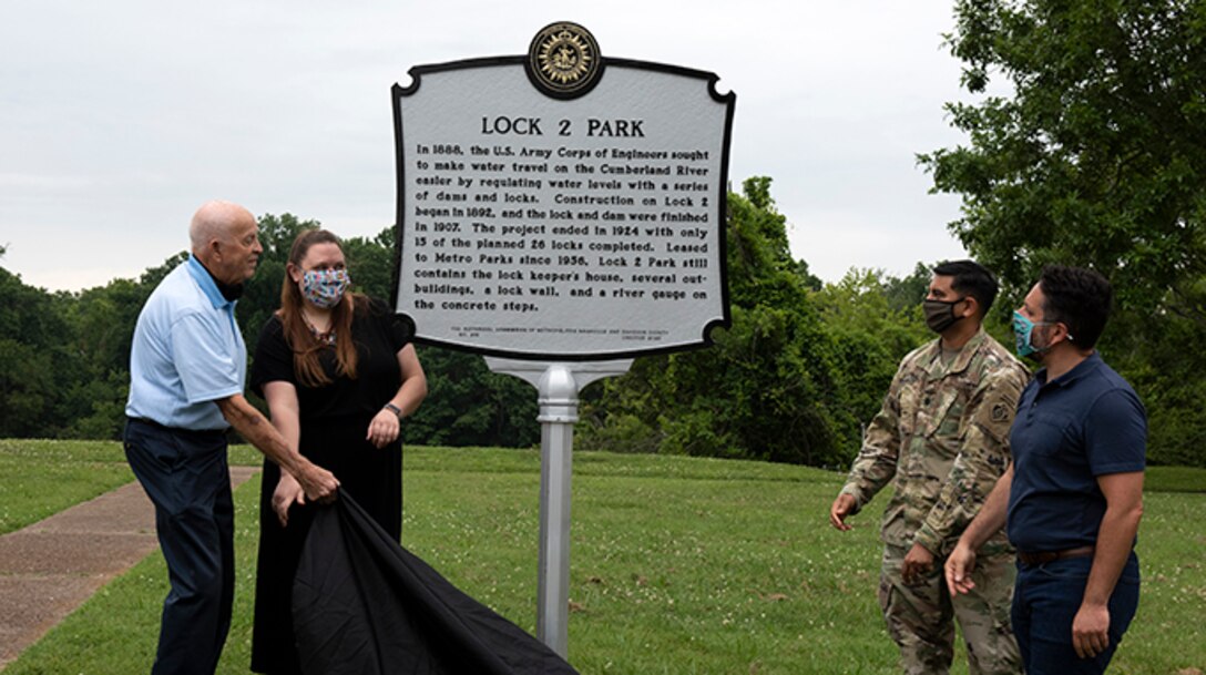 Jeff Syracuse, Metro Council member for District 15; Jessica Reeves, who oversees the historic markers program with the Metro Historical Commission; Lt. Col. Sonny Avichal, U.S. Army Corps of Engineers Nashville District commander; Bill Holman, grandson of former lockmaster Red Holman, unveil a historical marker during a ceremony at Lock 2 Park, highlighting the historical relevance of Lock and Dam 2. (USACE photo by Lee Roberts)