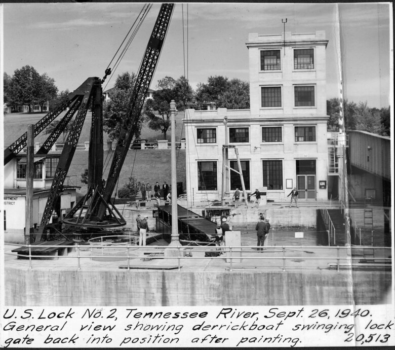 A derrick boat swings the lock gate into position after painting it at Lock 2 on the Cumberland River in Nashville, Tennessee, Sept. 26, 1940. The U.S. Army Corps of Engineers Nashville District built Lock and Dam 2 at this location to establish a navigation channel.  The structure was later replaced by today's modern dams. (USACE Photo)