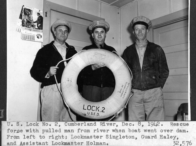 (Left to Right) Lockmaster Singleton, Guard Haley and Assistant Lockmaster Holman of the U.S. Army Corps of Engineers Nashville District pose after rescuing a man when his boat went over Dam 2 on the Cumberland River in Nashville, Tennessee, Dec. 8, 1942. (USACE Photo)