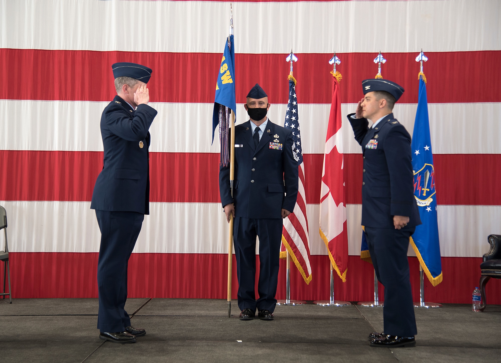 PETERSON AIR FORCE BASE, Colo. - Col. Sam Johnson, 21st Space Wing commander, left, salutes Col. David Wilson as he assumes command of the 21st Mission Support Group during a change of command ceremony June 24, 2020, at Peterson Air Force Base, Colorado. The traditional passing of the guidon did not occur in order to maintain proper physical distancing guidelines during the ceremony. (U.S. Air Force photo by Kristen Allen)