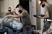 Airmen from the 432nd Aircraft Maintenance Squadron compete in a Load Crew of the Quarter competition, at Creech Air Force Base.