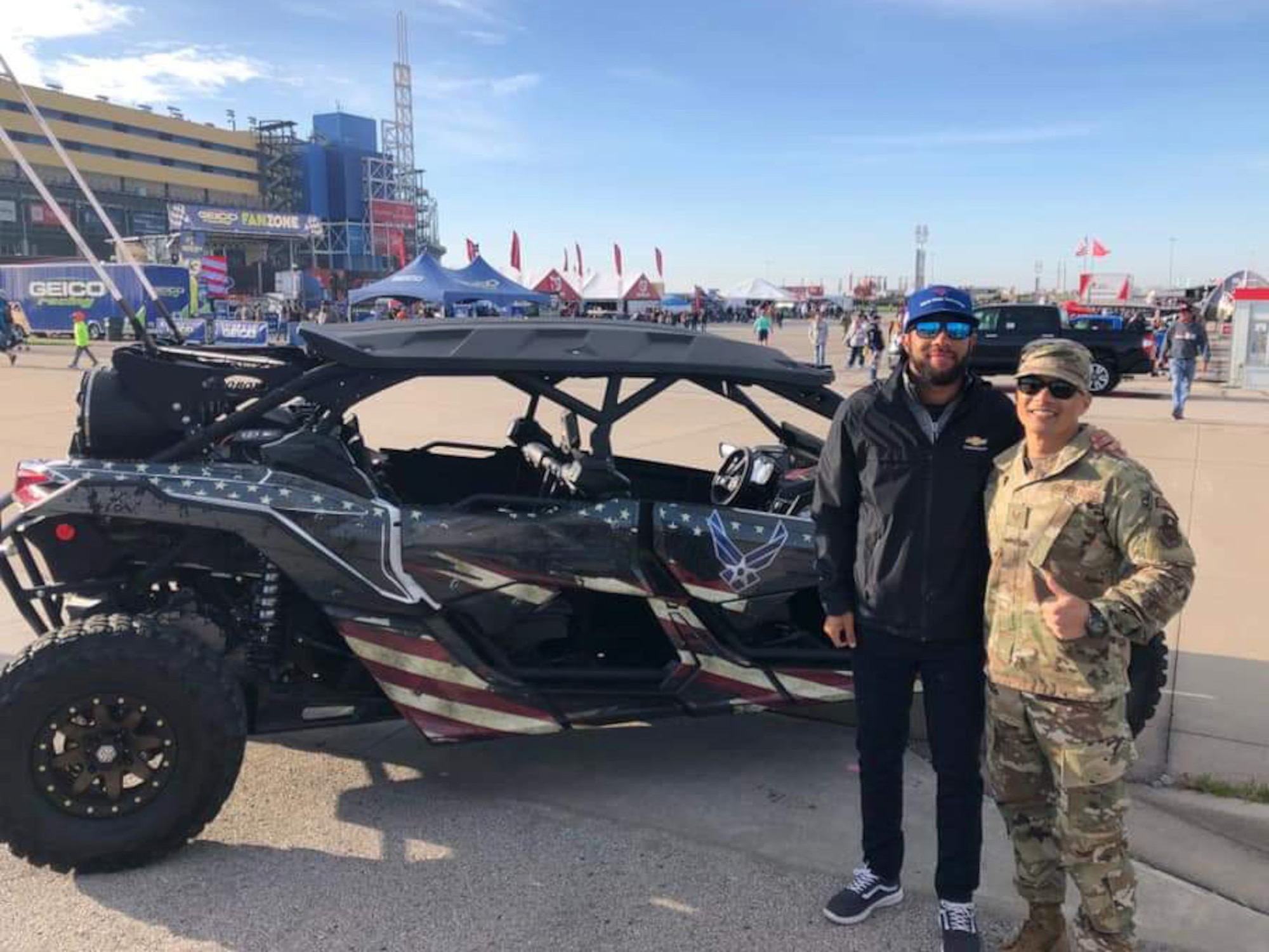 Bubba Wallace, the driver of the Air Force-sponsored Richard Petty Motorsport’s No. 43 car, poses with Tech. Sgt. Alvin Llamas, of the 349th Recruiting Squadron, in front of the squadron’s Bounty Hunter prior to the Hollywood Casino 400 race October, 20, 2019 in Kansas City, Kansas.