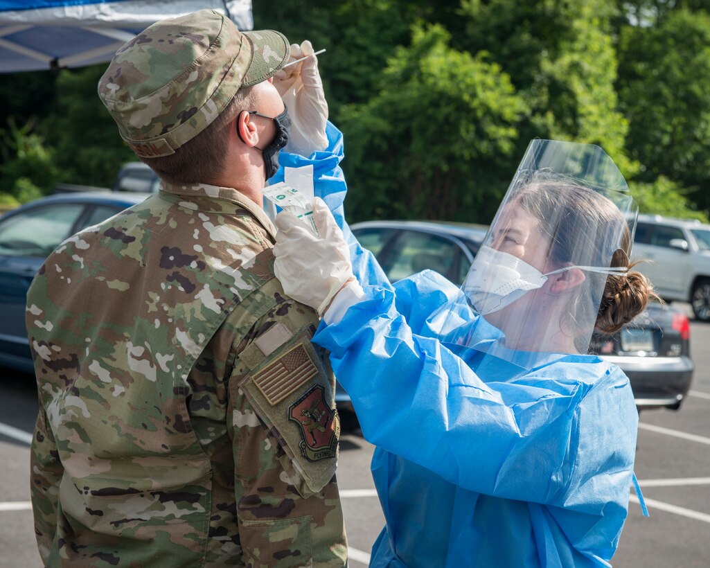 U.S. Air Force Staff Sgt. Carley Dolan, 103rd Medical Group aerospace medical technician, tests a 103rd Airlift Wing Airman for COVID-19 at Bradley Air National Guard Base, East Granby, Connecticut, June 19, 2020. The 103rd Medical Group worked in partnership with the Connecticut National Guard 14th Civil Support Team, New York National Guard 24th Civil Support Team, and Connecticut Department of Public Health to provide COVID-19 testing to Connecticut Air National Guard personnel. (U.S. Air National Guard photo by Staff Sgt. Steven Tucker)