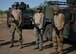 U.S. Air Force Airmen stand in front of military HUMVEE's holding training M-4 Carbines