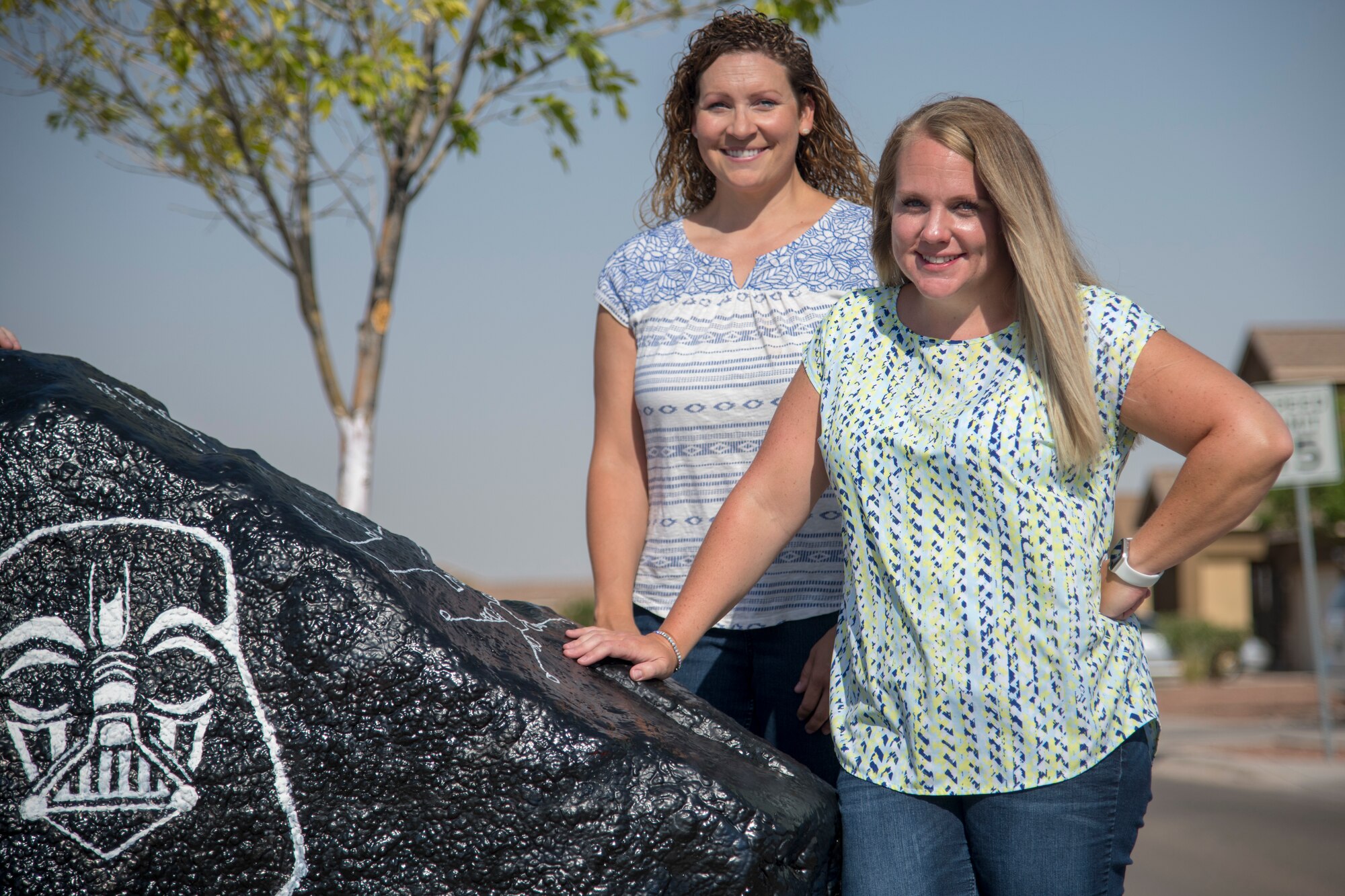Maj. Naomi Donovan, left, 924th Aircraft Maintenance Squadron commander and 2018 49th Mission Support Group key spouse, and Jackie Ottesen, 6th Attack Squadron key spouse, pose for a photo at the “Holloman rock,” June 23, 2020, on Holloman Air Force Base, N.M. Holloman key spouses paint this decorative rock approximately every two weeks to highlight fun events, holidays and general base awareness activities in order to promote community, cohesion and aid in putting a smile on Team Holloman members’ faces. (U.S. Air Force photo by Senior Airman Collette Brooks)