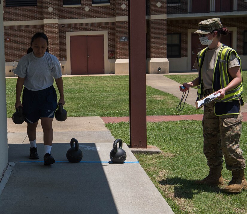 U.S. Air Force Airman 1st Class Gerica Arganosa, 633rd Medical Support Squadron medical lab tech, begins her turn during the Tunnell Hall Farmer’s Walk Kettle Bell Challenge at Joint Base Langley-Eustis, Virginia, June 19, 2020. The challenge consisted of female and male categories, awarding prizes to the first, second, and third place finishers of each group. (U.S. Air Force photo by Senior Airman Marcus M. Bullock)