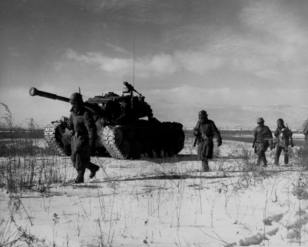 A column of troops and armor of the 1st Marine Division move through communist Chinese lines during their successful breakout from the Chosin Reservoir in North Korea.