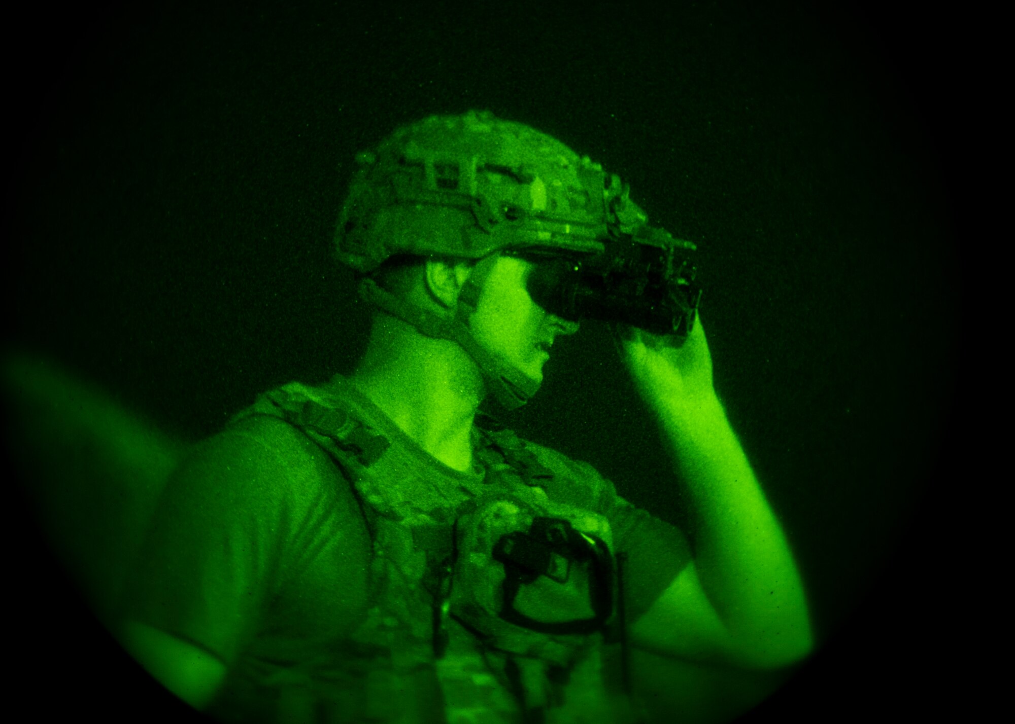 EOD Airmen adjusts his night vision goggles