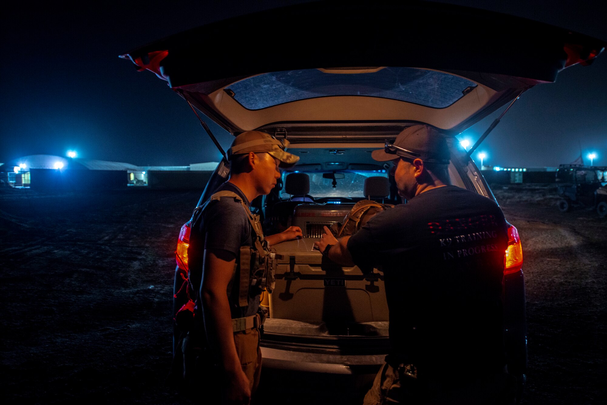 MWD handlers discuss training exercise