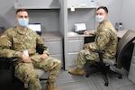 Spc. Lionel Courturier and Spc. William Casey, combat engineers with the 182nd Engineer Company (SAPPER), Massachusetts National Guard, take a quick break to brief the plans for the unit patch and T-shirt they designed while assigned to Task Force Steel Dragon June 18, 2020.  TF Steel Dragon is helping process a surge in unemployment cases submitted during the COVID-19 pandemic.