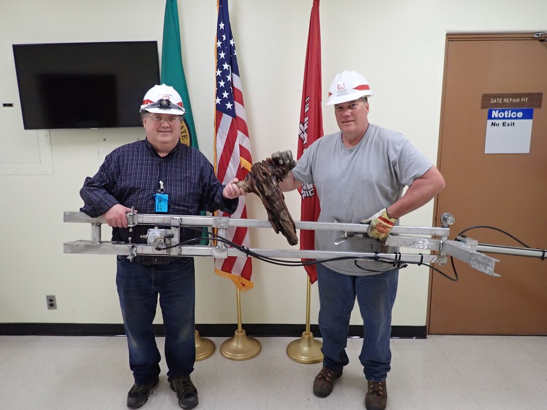 Jay Haugen and Kreg Buryta with their orifice debris plunger device after a successful test on May 5, 2020.