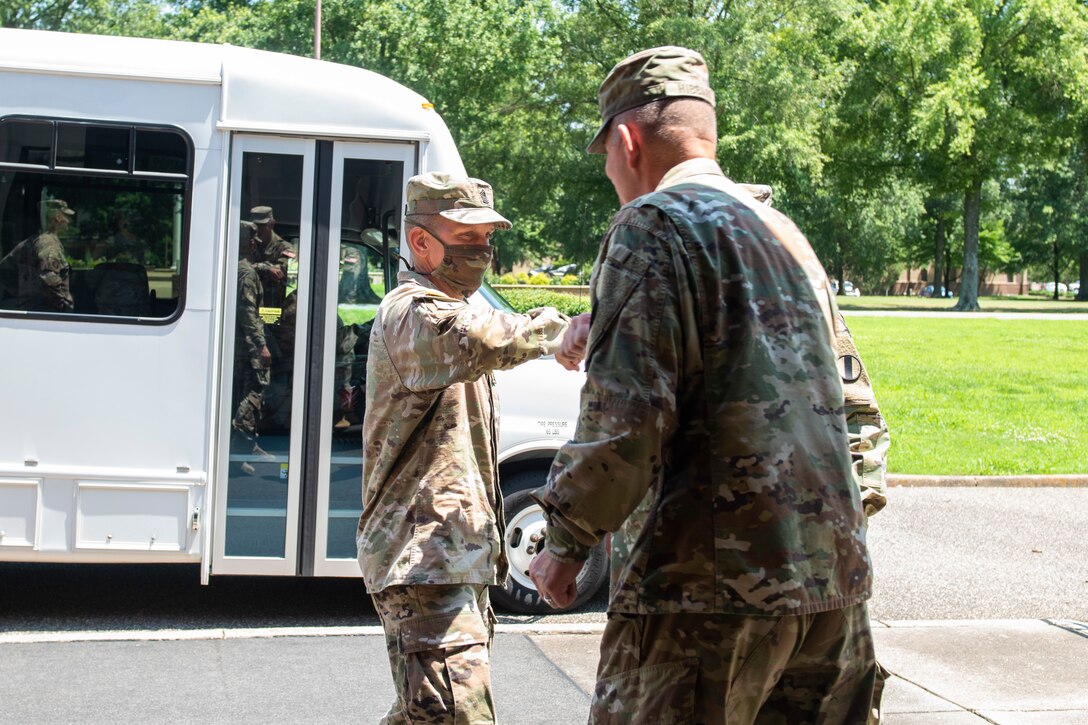 U.S. Army Maj. Gen. Lonnie Hibbard hits elbows with Sgt. Maj. of the Army Michael A. Grinston as a greeting.