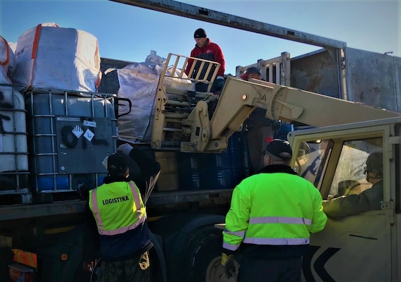 Hazardous waste is loaded onto a truck.