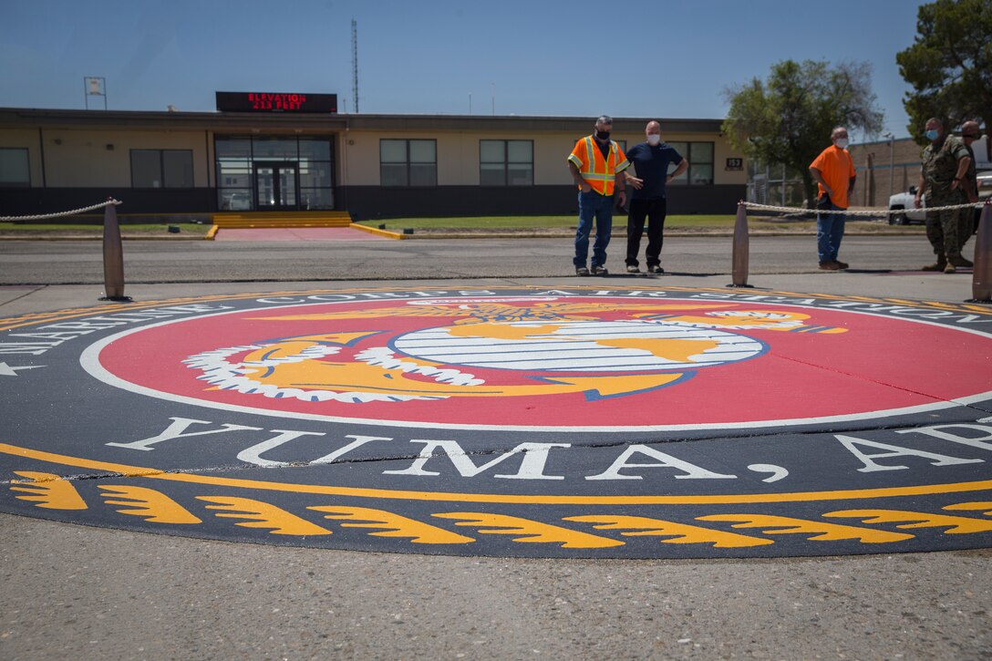 U.S. Marine Corps Col. David A. Suggs, commanding officer, Marine Corps Air Station (MCAS) Yuma, presents civilian contractors with a letter of appreciation (LOA) for their work on MCAS Yuma, at the MCAS Yuma base operations building, June 11, 2020.