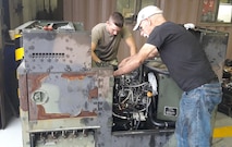 Photo of Field Service Representative Gary Dygert installing an engine