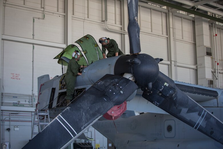 U.S. Marines Corps Cpl Kyle Sewer, left, and Cpl Reid Ellis Jr, MV-22 tiltrotor mechanics with Marine Operational Test and Evaluation Squadron (VMX) 1, conduct routine maintenance on a MV-22 Osprey on Marine Corps Air Station (MCAS) Yuma, June 18, 2020. VMX-1 is an operational test squadron that tests multiple aircraft, allowing the continuation of improving the safety, reliability, and lethality of Marine Corps aircraft. (U.S. Marine Corps photo by Lance Cpl John Hall)