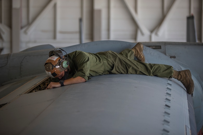 U.S. Marines Corps Cpl Reid Ellis Jr, a MV-22 tiltrotor mechanic with Marine Operational Test and Evaluation Squadron (VMX) 1, conducts routine maintenance on a MV-22 Osprey on Marine Corps Air Station (MCAS) Yuma, June 18, 2020. VMX-1 is an operational test squadron that tests multiple aircraft, allowing the continuation of improving the safety, reliability, and lethality of Marine Corps aircraft. (U.S. Marine Corps photo by Lance Cpl John Hall)