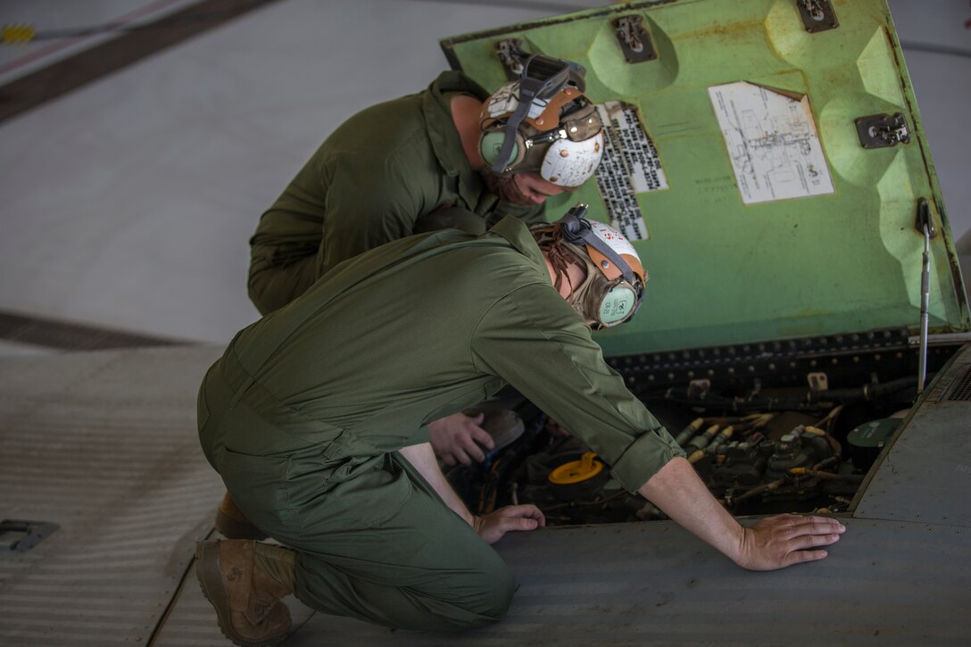 U.S. Marines Corps Cpl Kyle Sewer and Cpl Reid Ellis Jr, MV-22 tiltrotor mechanics with Marine Operational Test and Evaluation Squadron (VMX) 1, conduct routine maintenance on a MV-22 Osprey on Marine Corps Air Station (MCAS) Yuma, June 18, 2020.