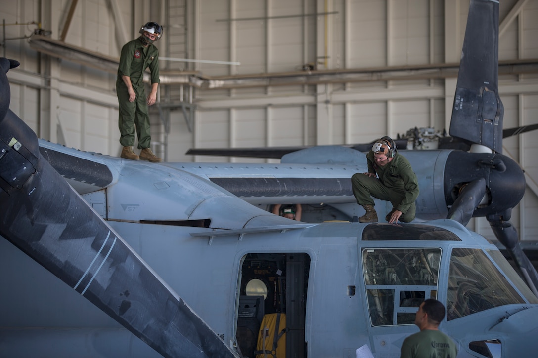 U.S. Marines Corps Cpl Kyle Sewer, right, and Cpl Reid Ellis Jr MV-22 tiltrotor mechanics with Marine Operational Test and Evaluation Squadron (VMX) 1, conduct routine maintenance on a MV-22 Osprey on Marine Corps Air Station (MCAS) Yuma, June 18, 2020. VMX-1 is an operational test squadron that tests multiple aircraft, allowing the continuation of improving the safety, reliability, and lethality of Marine Corps aircraft. (U.S. Marine Corps photo by Lance Cpl John Hall)