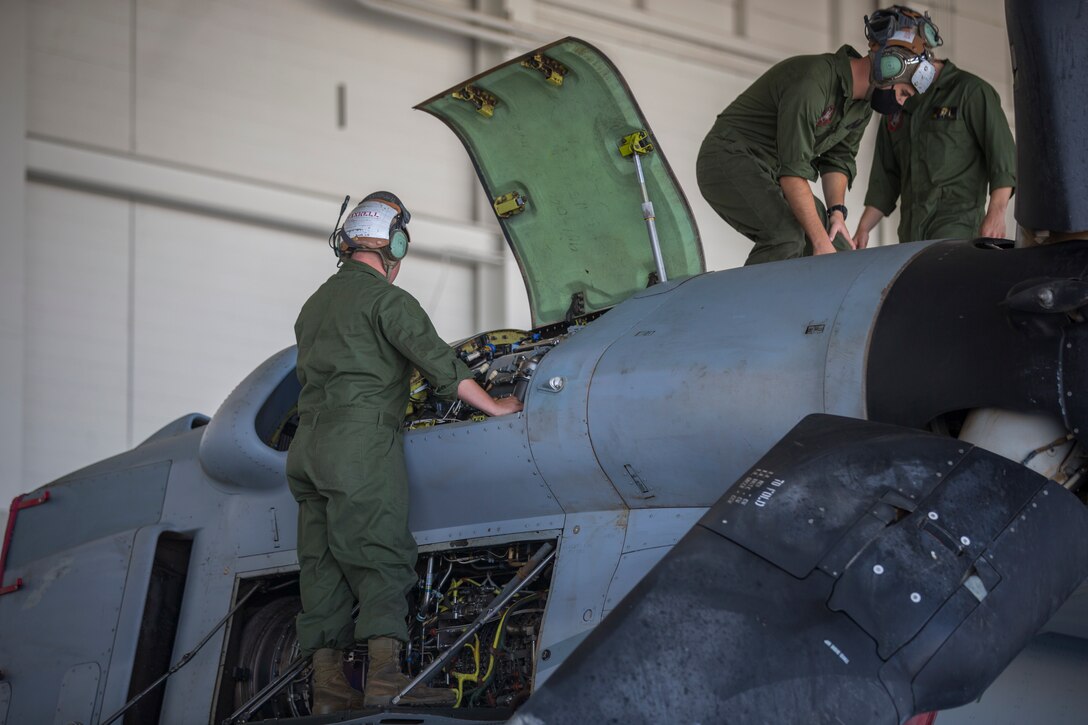 U.S. Marines Corps Cpl Kyle Sewer, left, and Cpl Reid Ellis Jr, MV-22 tiltrotor mechanics with Marine Operational Test and Evaluation Squadron (VMX) 1, conduct routine maintenance on a MV-22 Osprey on Marine Corps Air Station (MCAS) Yuma, June 18, 2020. VMX-1 is an operational test squadron that tests multiple aircraft, allowing the continuation of improving the safety, reliability, and lethality of Marine Corps aircraft. (U.S. Marine Corps photo by Lance Cpl John Hall)