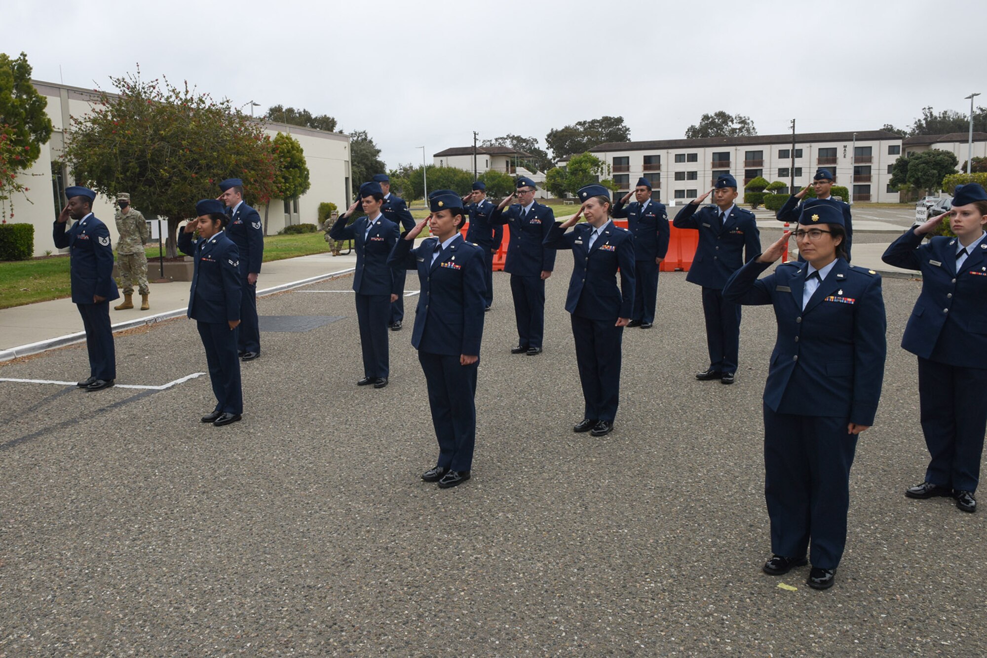 Photo of 30th Medical Group members saluting in formation