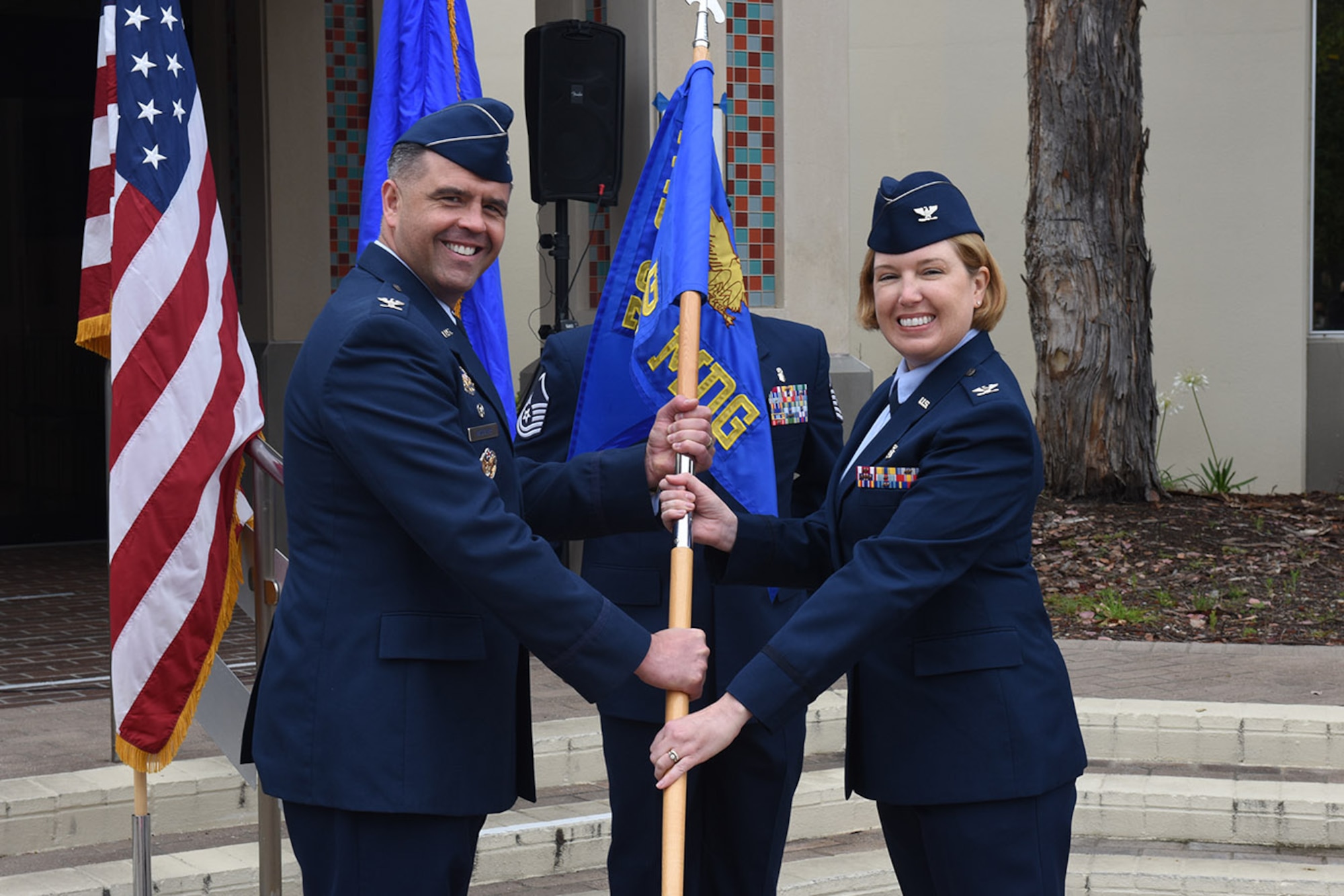 Photo of Colonel Mastalir and Colonel Spitler holding 30th Medical Group guidon