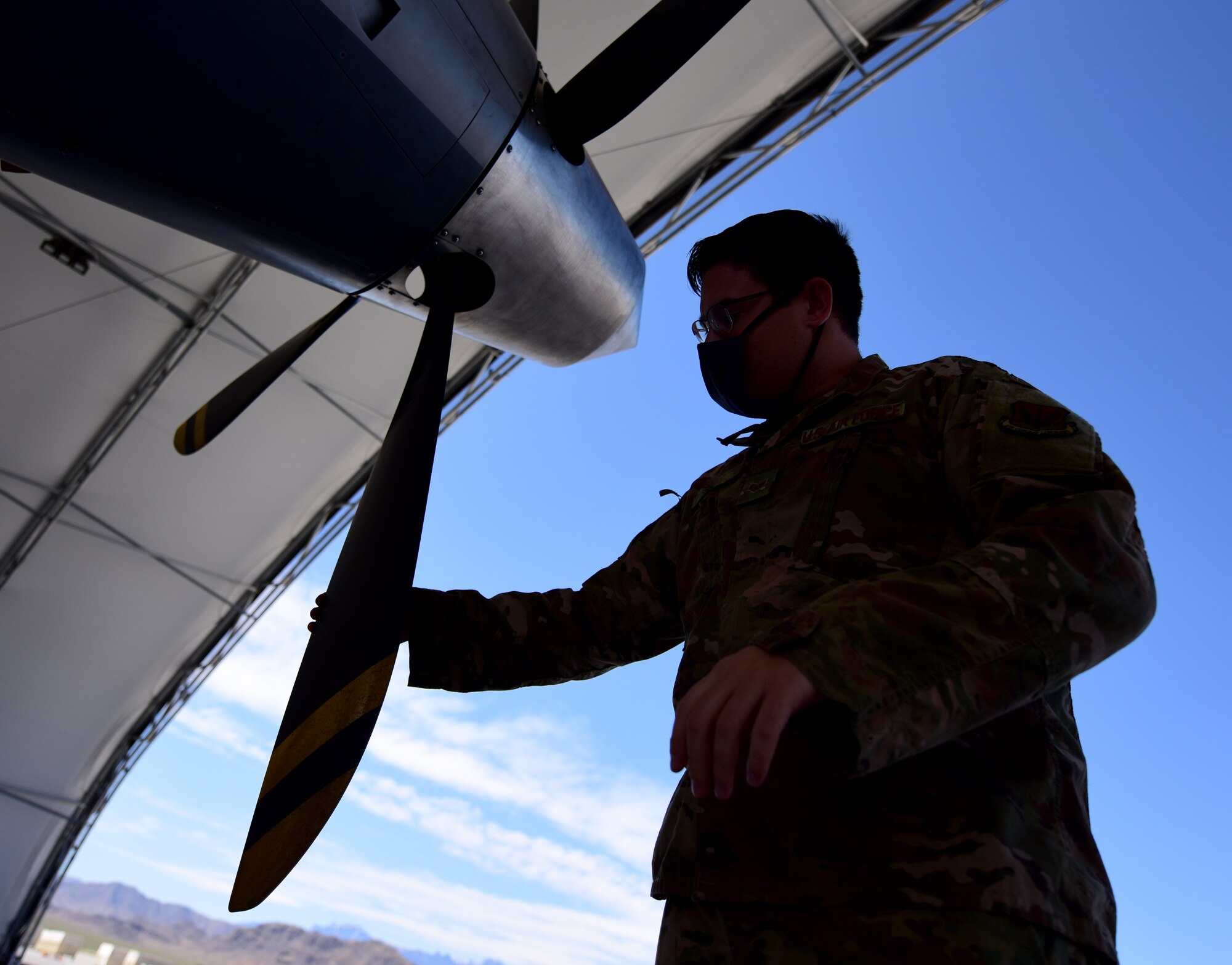 Staff Sgt. Hunter, 432nd Aircraft Maintenance Squadron crew chief, inspects the rotors of an MQ-9 Reaper.