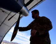 Staff Sgt. Hunter, 432nd Aircraft Maintenance Squadron crew chief, inspects the rotors of an MQ-9 Reaper.