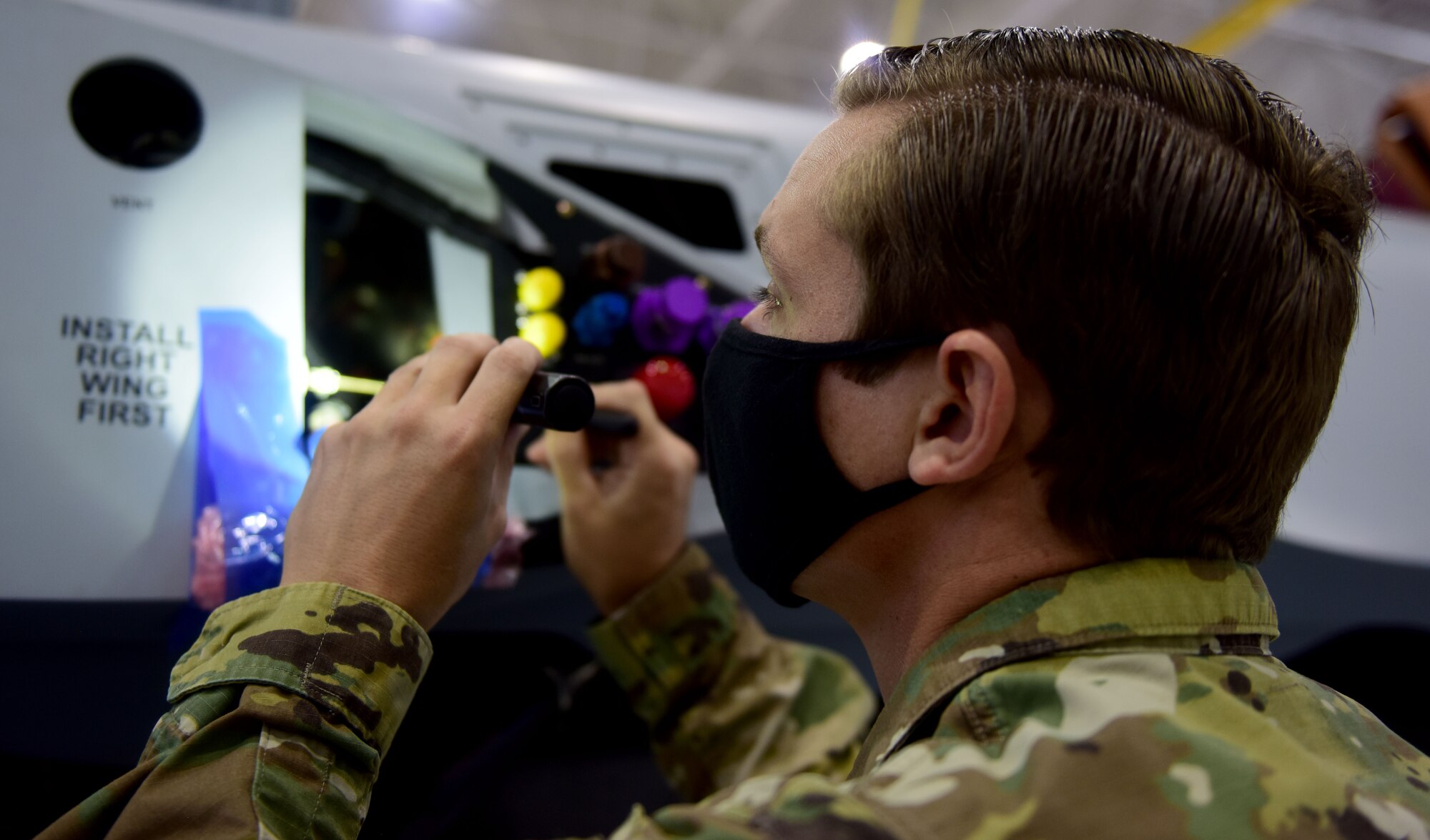 Staff Sgt. Anthony, 432nd Aircraft Maintenance Squadron crew chief, checks inside the panels of an MQ-9 Reaper.