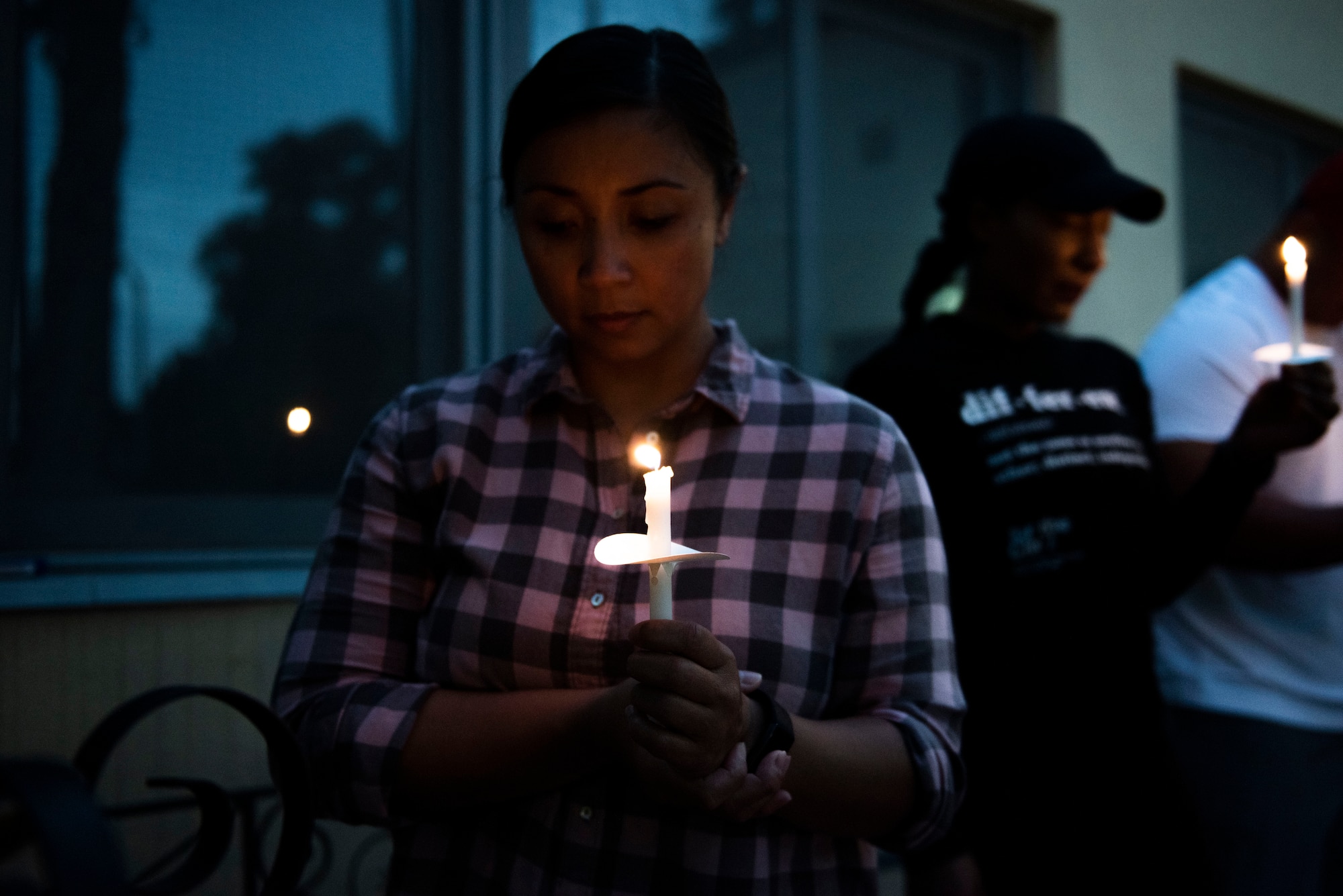 U.S. Air Force Chief Master Sgt. Maribeth Ferrer, 39th Medical Group superintendent, attends a candlelight vigil for racial equality June 17, 2020, at Incirlik Air Base, Turkey. Ferrer joined the Air Force two years after emigrating from the Philippines to the U.S. (U.S. Air Force Staff Sgt. Joshua Magbanua)