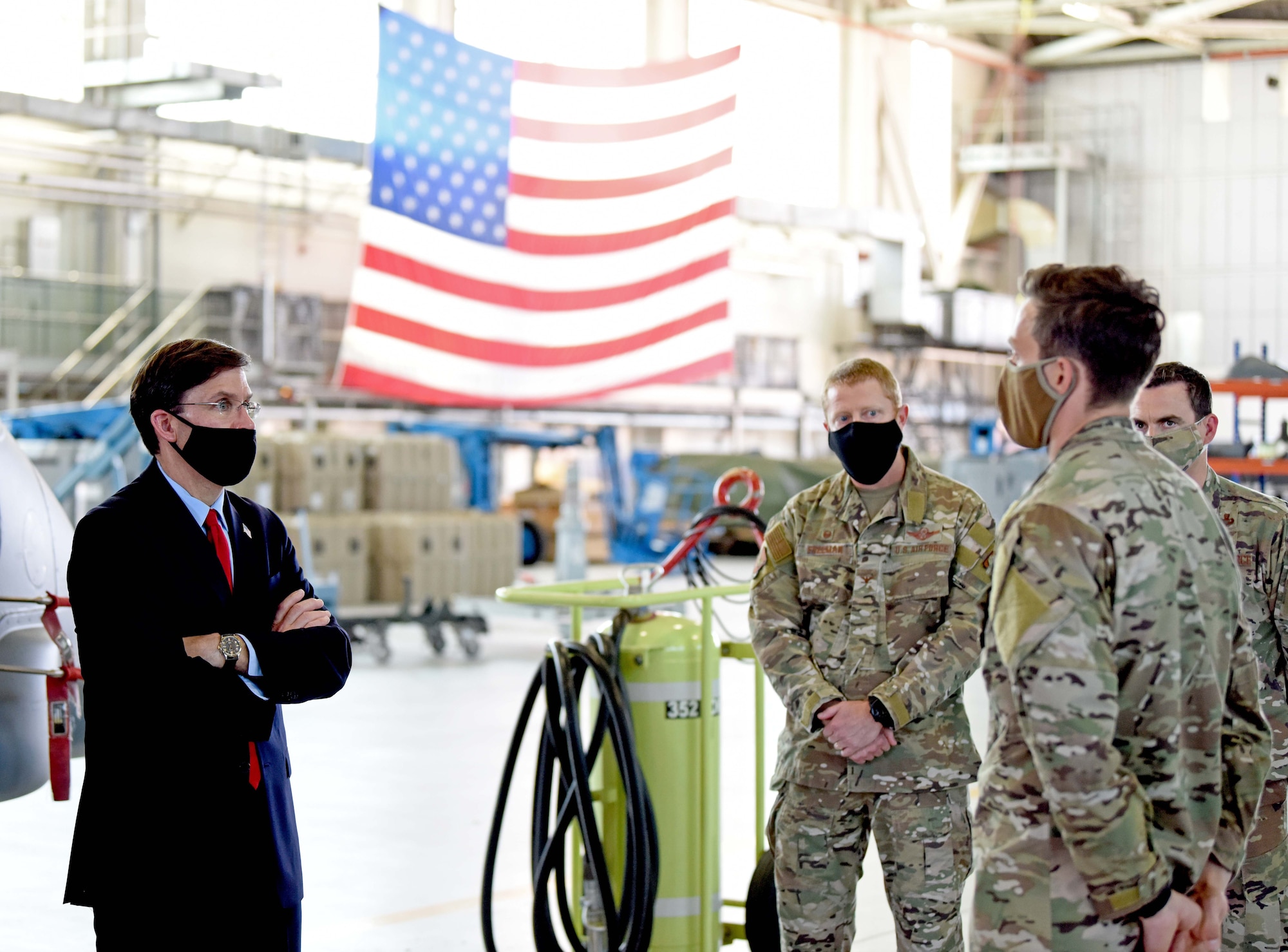 U.S. Secretary of Defense Dr. Mark T. Esper speaks with a 352nd Special Operations Wing air commando during a visit to RAF Mildenhall, England, June 25, 2020. Esper toured the air traffic control tower, static displays of a CV-22 Osprey, RC-135 Rivet Joint and spent time speaking with both officer and enlisted Airmen during his tour. (U.S. Air Force photo by Senior Airman Brandon Esau)