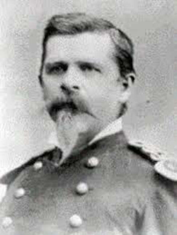 A bearded man poses in a Civil War-era uniform.