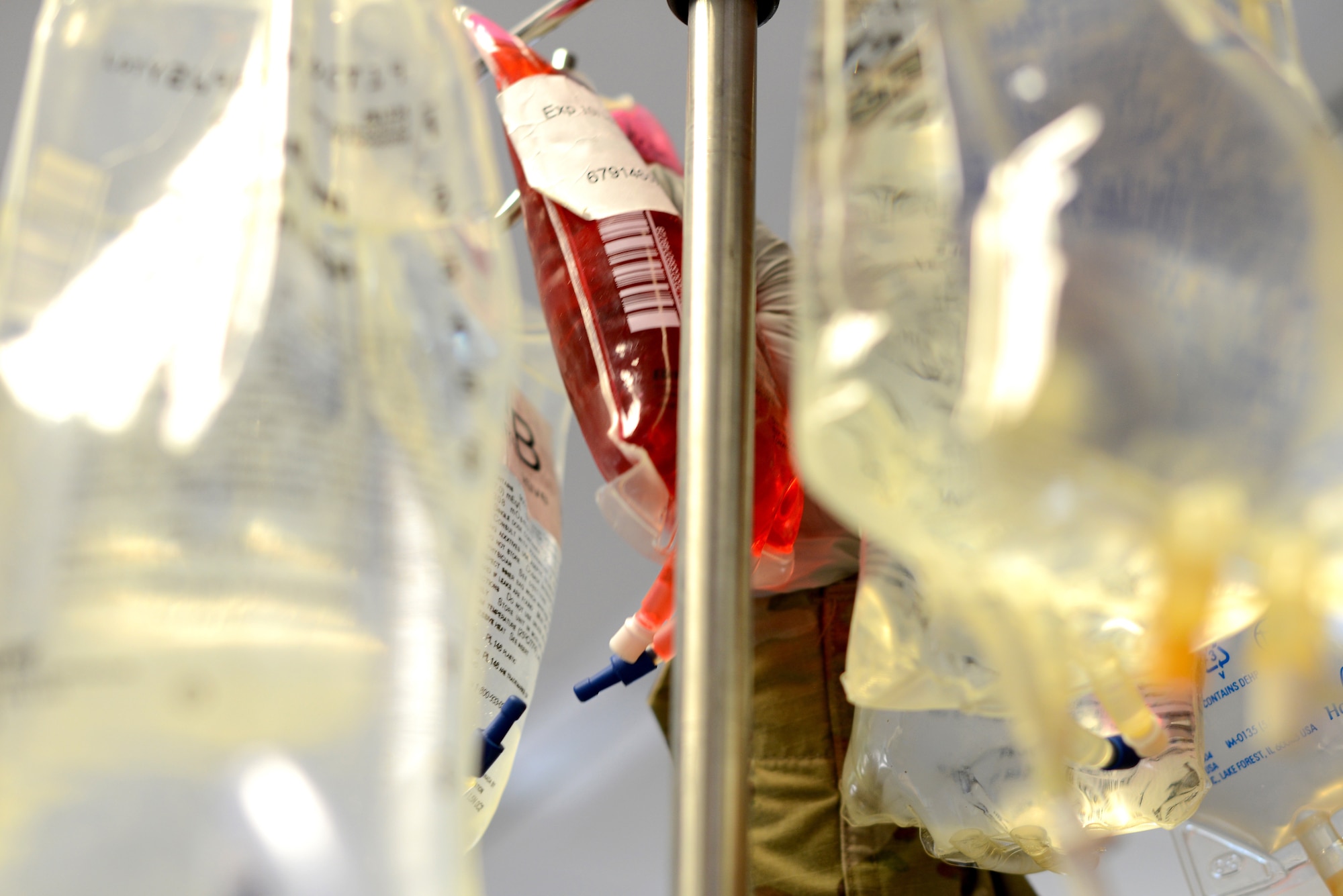 U.S. Army Spec. Alexandra Jimenez, 67th Forward Resuscitative Surgical Team licensed practical nurse hangs notional blood on the Belmont Rapid Infuser during a training scenario at the Medical Simulation Training Center, Ramstein Air Base, June 19, 2020.
