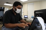 Spc. Carlos Cirano, a security analyst assigned to the North Carolina National Guard Cyber Security Response Force (CSRF), conducts cyber operations at a city of Roxboro facility in Roxboro, North Carolina, June 18, 2020.  The CSRF helped restore city and county computer networks after a cyberattack in late May.