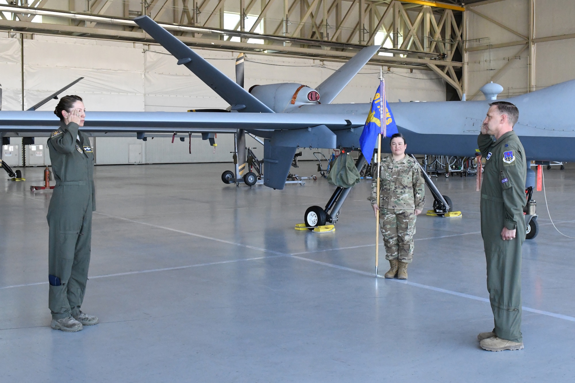 Col. Karyn L. Christen, 726th Operations Group commander, returns a salute to Lt. Col. Arthur A. Thompson, incoming 91st Attack Squadron commander, as Thompson accepts command of the 91st ATKS, June 19, 2020, Creech Air Force Base, Nevada. The Change of Command ceremony was modified to honor the heritage of the passing of the wing guidon while maintaining current social distancing guidelines. (U.S. Air Force photo by Natalie Stanley)