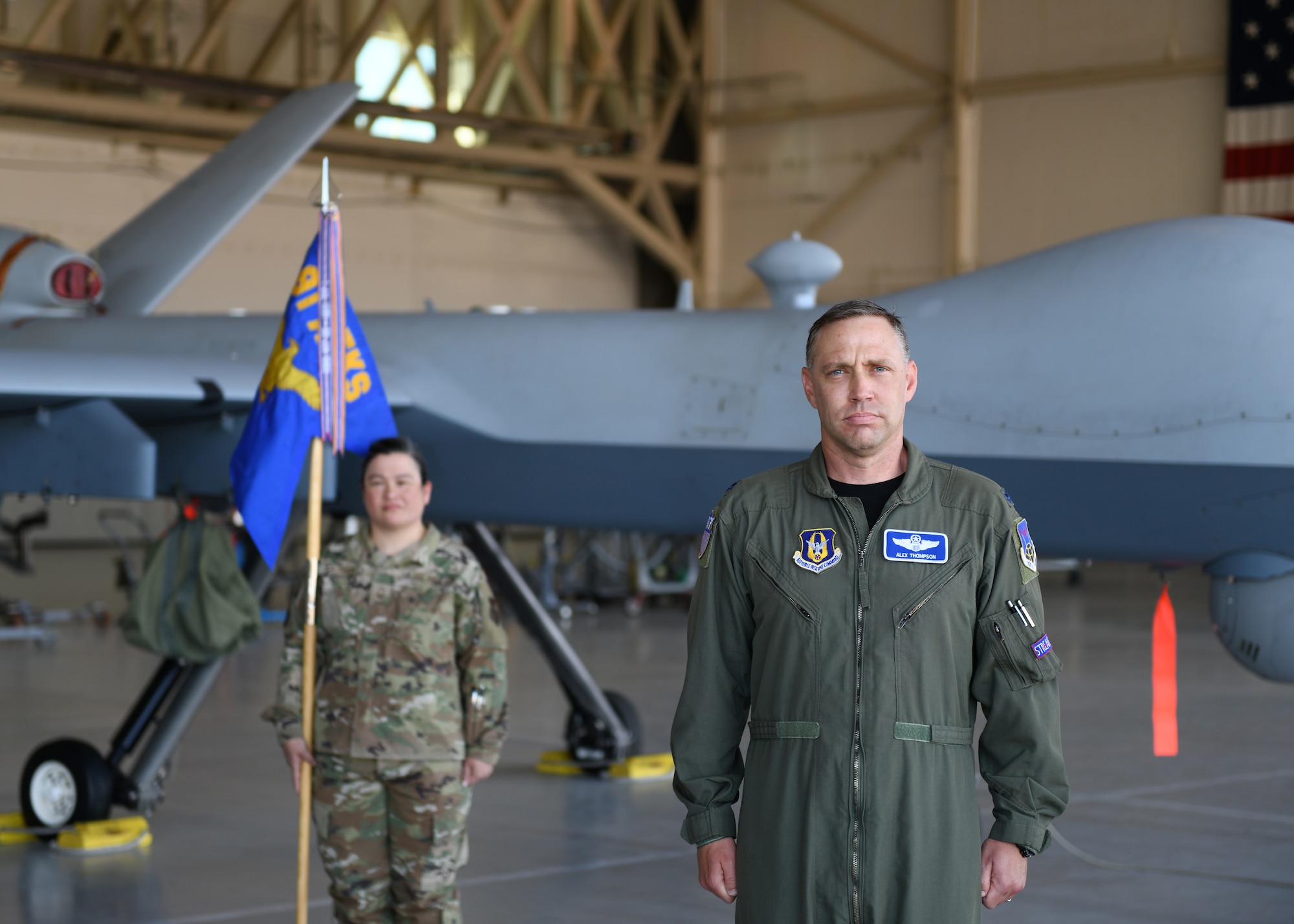 Lt. Col. Arthur A. Thompson accepts command of the 91st Attack Squadron, June 19, 2020, Creech Air Force Base, Nevada. The Change of Command ceremony was modified to honor the heritage of the passing of the wing guidon while maintaining current social distancing guidelines. (U.S. Air Force photo by Natalie Stanley)