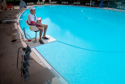 Lifeguard Brandon Mercado looks out over an empty pool at Joint Base San Antonio-Randolph on June 25, the second day the JBSA pools were open for the summer.