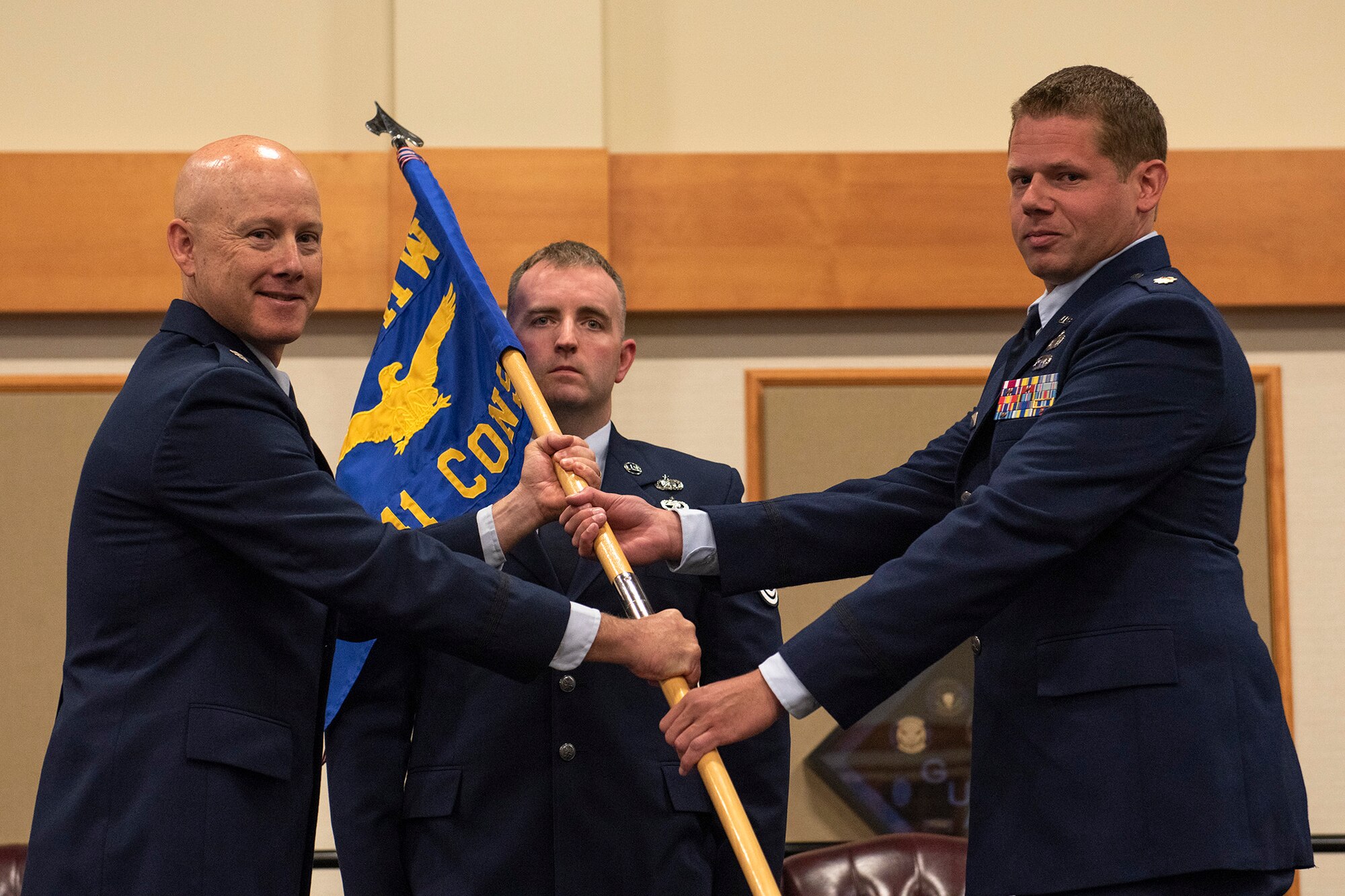 Maj. Matthew Bublitz, right, accepts command of the 341st Contracting Squadron from Lt. Col. Jonathan Lawson, 341st Mission Support Group deputy commander, during a change of command ceremony June 25, 2020, at Malmstrom Air Force Base, Mont.