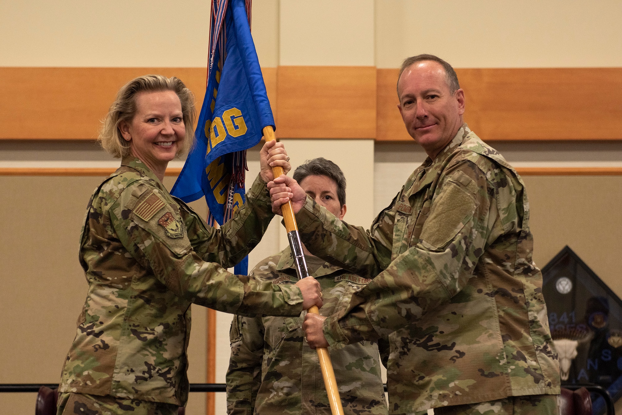 Col. Mark Pomerinke, right, accepts command of the 341st Medical Group from Col. Jennifer Reeves, 341st Missile Wing commander, during a change of command ceremony June 26, 2020, at Malmstrom Air Force Base, Mont.