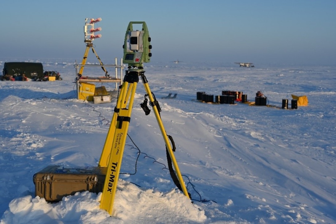 A Gamma Portable Radar Interferometer and a Robotic Laser Theodolite sit on top of a large pressure ridge near a U.S. Navy ice camp on the Beaufort Sea, March 4, 2020. The Gamma Portable Radar Interferometer continuously measures precise distances from itself to an array of reflectors deployed around the camp and runway. It is able to detect small movements of the reflectors in relation to each other, and can tell researchers how the ice is expanding and contracting. The radar interferometer in an alternate method to accomplish a similar goal, sending out radar pulses that reflect off of various ice surfaces and records the reflected signal.